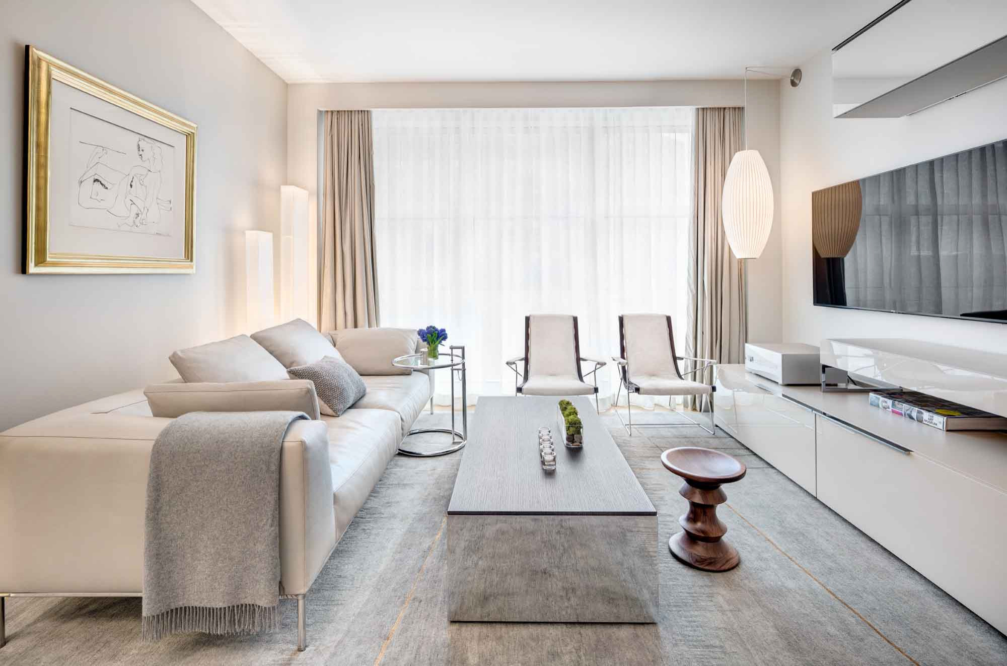Bowery Residence Renovation — renovated living room with custom-framed art